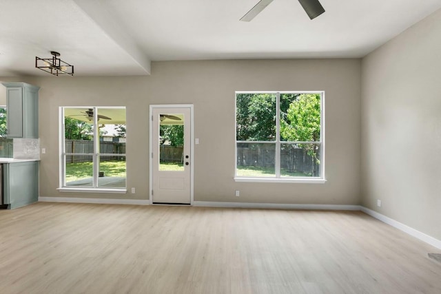 7057 Thistle Hill Way, Austin, TX 78754 - unfurnished living room featuring ceiling fan, light wood finished floors, and baseboards