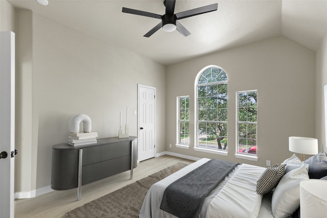 7057 Thistle Hill Way, Austin, TX 78754 - bedroom with light wood-type flooring, baseboards, lofted ceiling, and ceiling fan