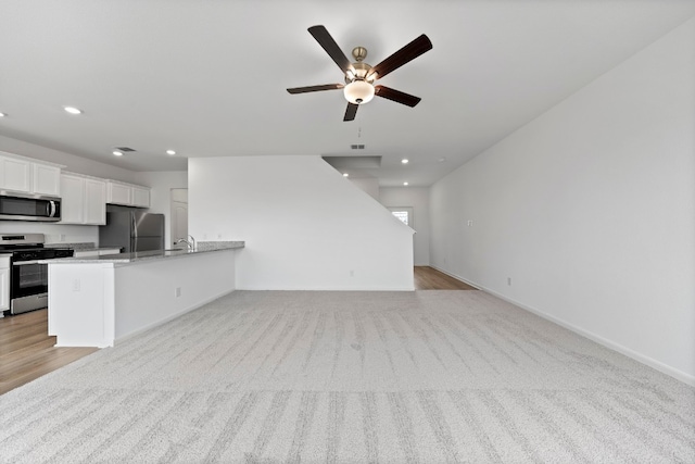 508 Aplite Pass, Maxwell, TX 78656 - kitchen with stainless steel appliances, ceiling fan, recessed lighting, open floor plan, and light carpet
