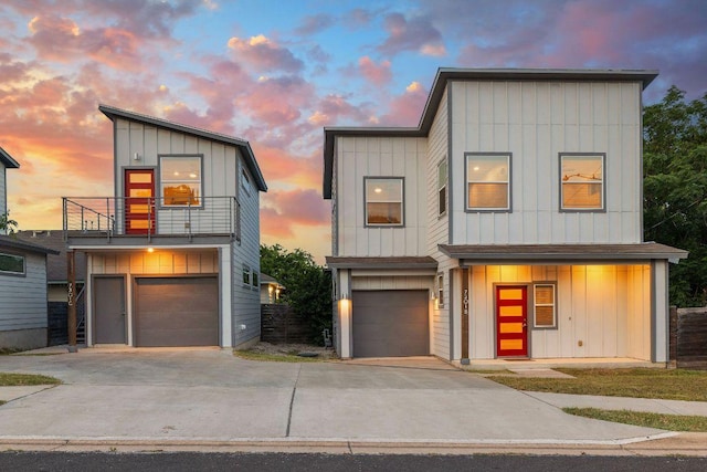 7301 Providence Ave Unit B, Austin, TX 78752 - contemporary house with a balcony, board and batten siding, an attached garage, and driveway