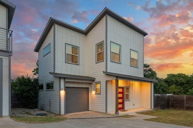 7301 Providence Ave Unit B, Austin, TX 78752 - contemporary house featuring board and batten siding, an attached garage, and concrete driveway