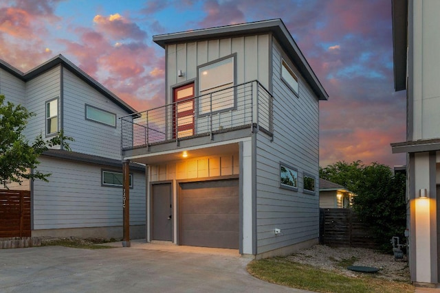 7301 Providence Ave Unit B, Austin, TX 78752 - view of front of property featuring a balcony, driveway, a garage, and board and batten siding
