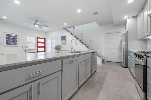 7301 Providence Ave Unit B, Austin, TX 78752 - kitchen with a sink, stainless steel appliances, gray cabinets, ceiling fan, and recessed lighting