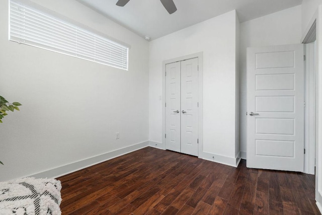 7301 Providence Ave Unit B, Austin, TX 78752 - unfurnished bedroom featuring dark wood-style flooring, baseboards, a closet, and a ceiling fan