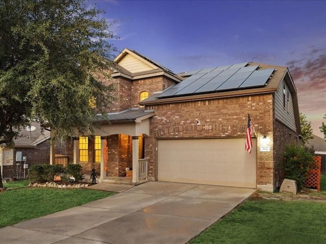 362 Maple Way, New Braunfels, TX 78132 - view of front of house with brick siding, roof mounted solar panels, concrete driveway, a lawn, and an attached garage