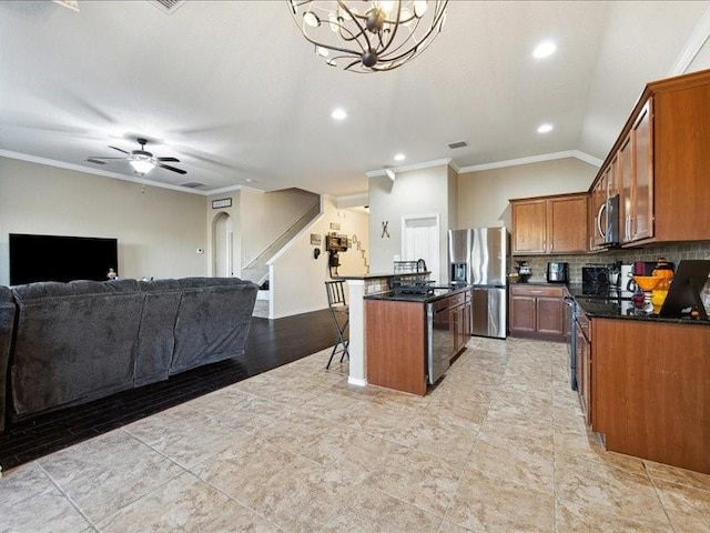 362 Maple Way, New Braunfels, TX 78132 - kitchen featuring appliances with stainless steel finishes, ornamental molding, brown cabinetry, a kitchen bar, and open floor plan