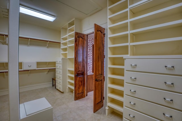 530 Scenic View Dr, Marble Falls, TX 78654 - spacious closet featuring attic access and light tile patterned floors