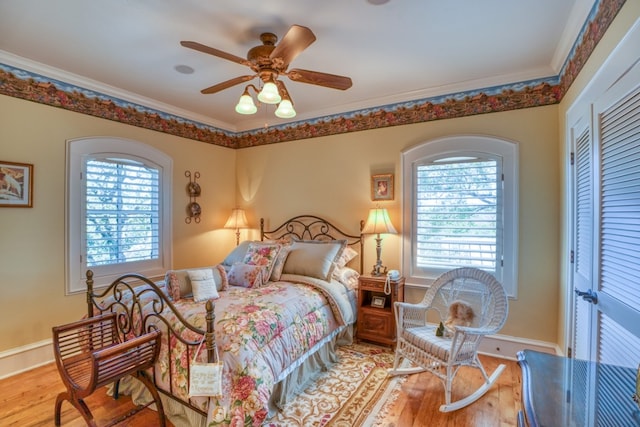 530 Scenic View Dr, Marble Falls, TX 78654 - bedroom with wood finished floors, crown molding, baseboards, a closet, and a ceiling fan