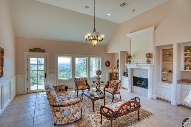 530 Scenic View Dr, Marble Falls, TX 78654 - living room featuring built in shelves, wainscoting, a decorative wall, a chandelier, and a fireplace