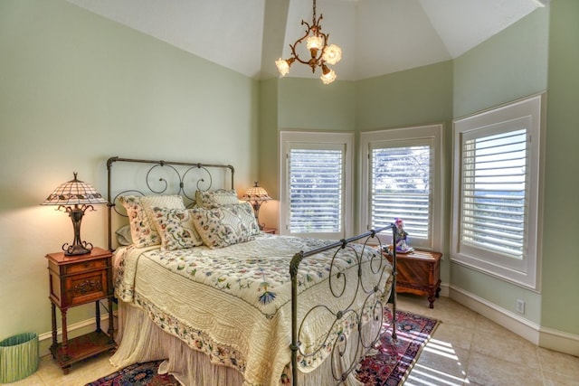 530 Scenic View Dr, Marble Falls, TX 78654 - bedroom with tile patterned flooring, baseboards, high vaulted ceiling, and a chandelier