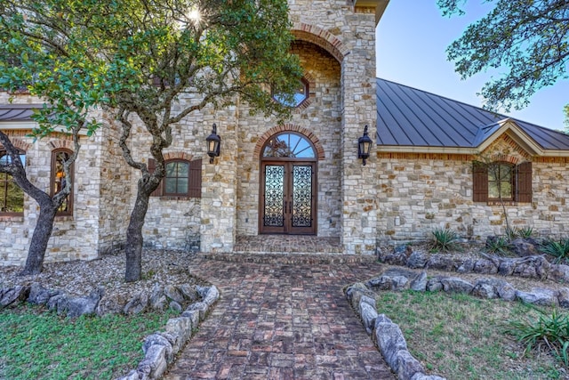 530 Scenic View Dr, Marble Falls, TX 78654 - view of exterior entry with a standing seam roof, metal roof, stone siding, and french doors