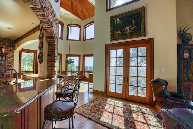 530 Scenic View Dr, Marble Falls, TX 78654 - entrance foyer featuring arched walkways, a towering ceiling, wood-type flooring, and french doors
