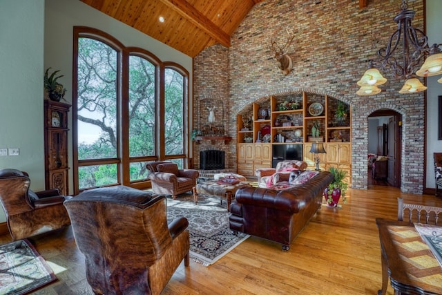 530 Scenic View Dr, Marble Falls, TX 78654 - living area featuring high vaulted ceiling, arched walkways, wood ceiling with exposed beams, wood finished floors, and a chandelier