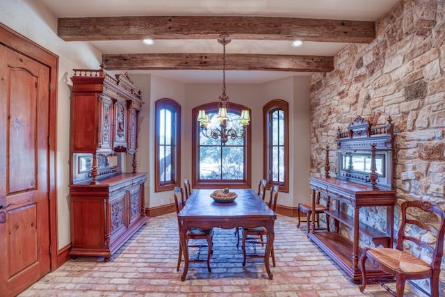 530 Scenic View Dr, Marble Falls, TX 78654 - dining room featuring a chandelier, brick floors, plenty of natural light, baseboards, and beamed ceiling