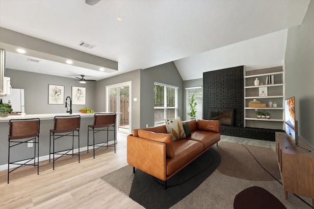 8330 Fathom Cir Unit 404, Austin, TX 78750 - living room with a ceiling fan, healthy amount of natural light, light wood-style floors, a brick fireplace, and recessed lighting