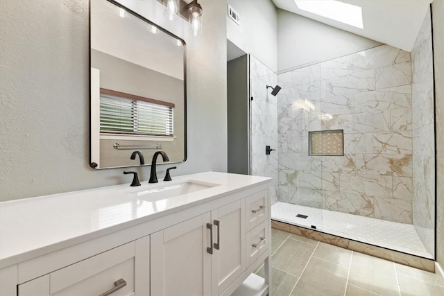 8330 Fathom Cir Unit 404, Austin, TX 78750 - full bath featuring a marble finish shower, vanity, a skylight, tile patterned floors, and lofted ceiling