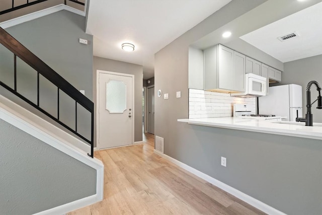 8330 Fathom Cir Unit 404, Austin, TX 78750 - entryway featuring light wood finished floors, baseboards, and stairway