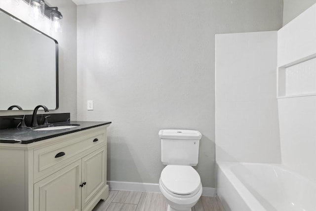 8330 Fathom Cir Unit 404, Austin, TX 78750 - full bathroom with toilet, wood finished floors, baseboards, and vanity