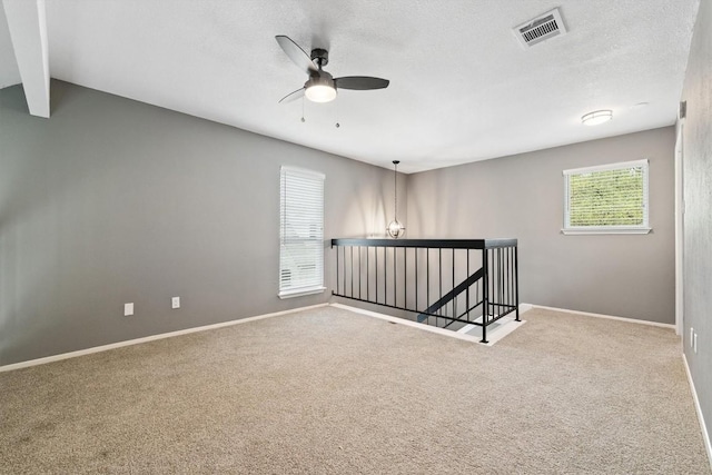 8330 Fathom Cir Unit 404, Austin, TX 78750 - carpeted empty room featuring ceiling fan, baseboards, and a textured ceiling