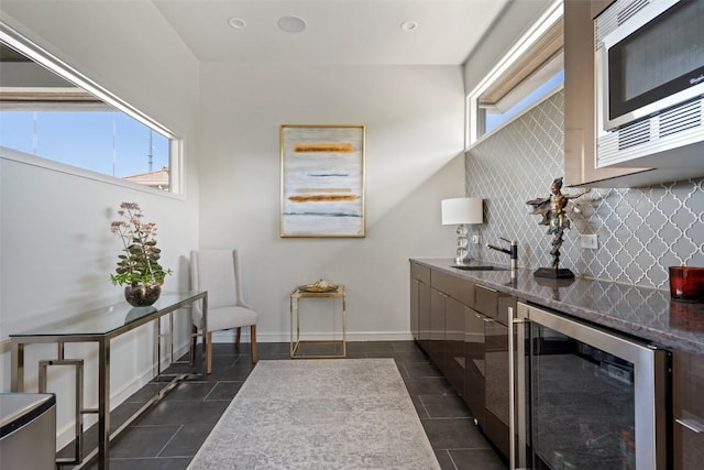 2551 Waymaker Way, Austin, TX 78746 - bathroom featuring beverage cooler, tasteful backsplash, tile patterned flooring, and vanity