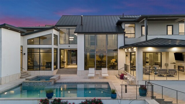 2551 Waymaker Way, Austin, TX 78746 - rear view of house featuring a standing seam roof, a patio area, metal roof, and a pool with connected hot tub