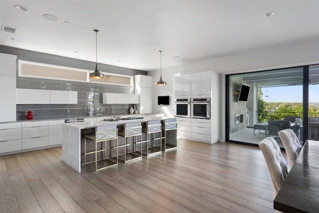 2551 Waymaker Way, Austin, TX 78746 - kitchen featuring appliances with stainless steel finishes, modern cabinets, decorative backsplash, white cabinets, and recessed lighting