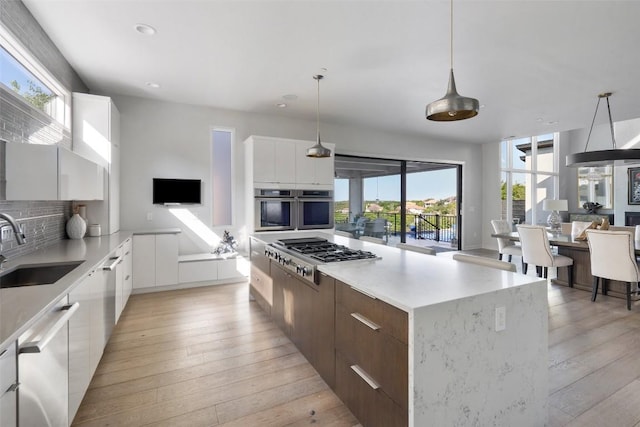 2551 Waymaker Way, Austin, TX 78746 - kitchen featuring modern cabinets, appliances with stainless steel finishes, a sink, plenty of natural light, and recessed lighting