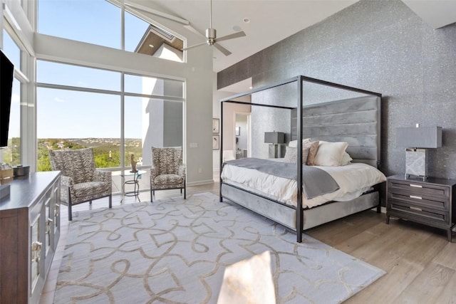 2551 Waymaker Way, Austin, TX 78746 - bedroom featuring wood finished floors and a high ceiling