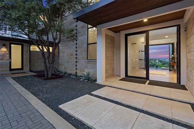 2551 Waymaker Way, Austin, TX 78746 - exterior entry at dusk featuring stone siding