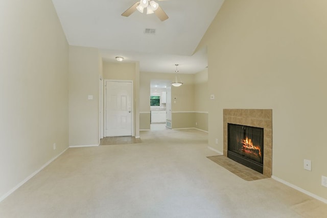 11970 Jollyville Rd Unit 214, Austin, TX 78759 - unfurnished living room with a tile fireplace, a ceiling fan, light colored carpet, and baseboards