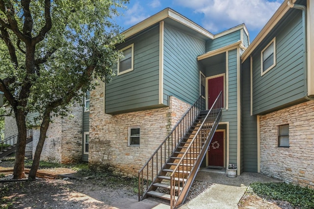 11970 Jollyville Rd Unit 214, Austin, TX 78759 - rear view of property with stone siding and stairway