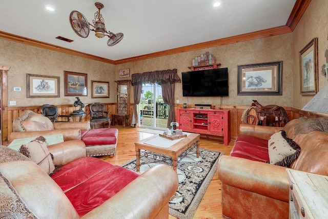 1110 County Road 487, Taylor, TX 76574 - living area featuring light wood finished floors, ornamental molding, a wainscoted wall, and recessed lighting