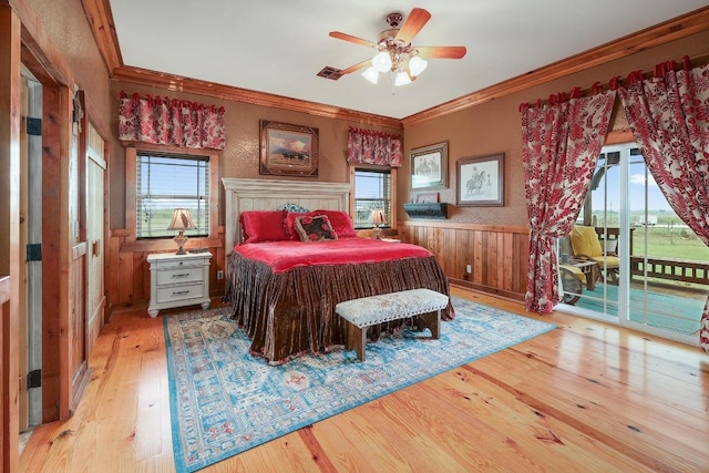 1110 County Road 487, Taylor, TX 76574 - bedroom featuring access to outside, light wood-style flooring, a wainscoted wall, ornamental molding, and wood walls