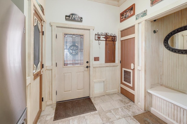 1110 County Road 487, Taylor, TX 76574 - mudroom featuring wainscoting, ornamental molding, and a decorative wall