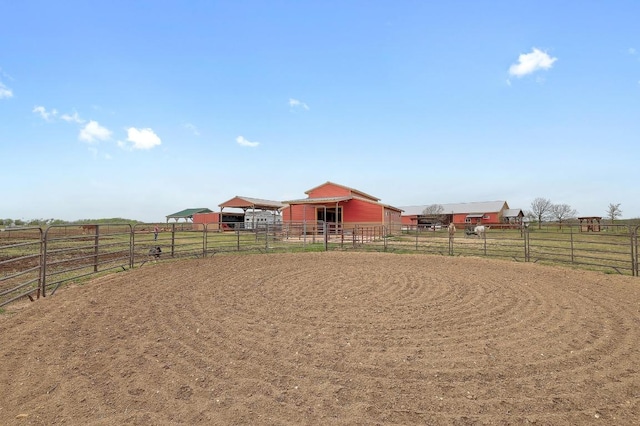 1110 County Road 487, Taylor, TX 76574 - view of yard featuring a view of countryside, an enclosed horse arena, an exterior structure, and an outdoor structure