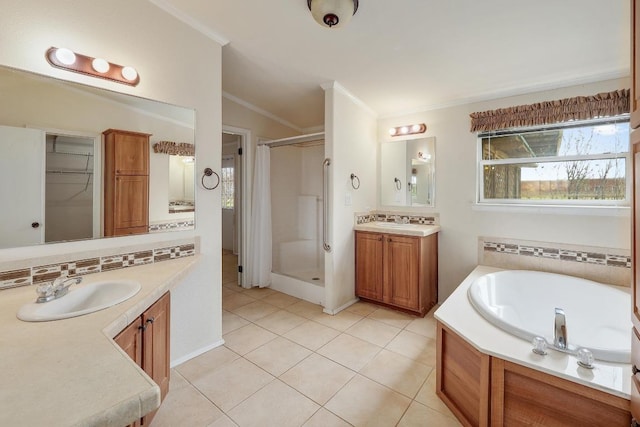 1110 County Road 487, Taylor, TX 76574 - bathroom with a stall shower, ornamental molding, two vanities, tile patterned flooring, and a bath