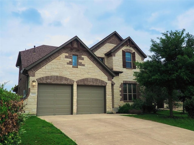 1902 Aves Cv, Pflugerville, TX 78660 - french provincial home featuring stone siding, driveway, and an attached garage