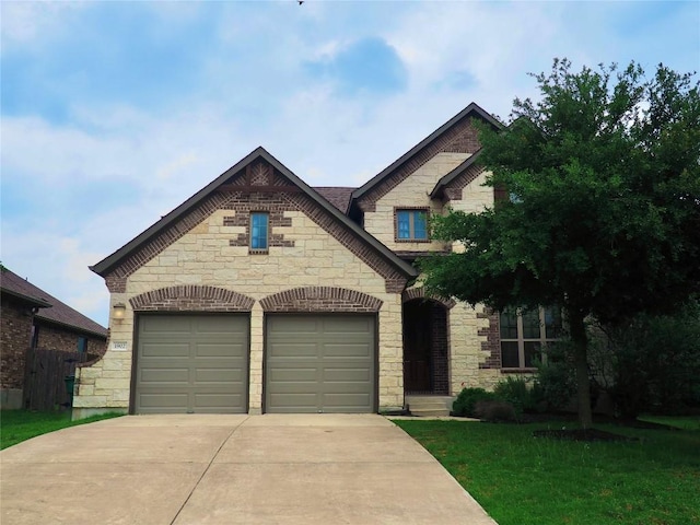 1902 Aves Cv, Pflugerville, TX 78660 - view of front of property featuring stone siding, driveway, a garage, and a front lawn