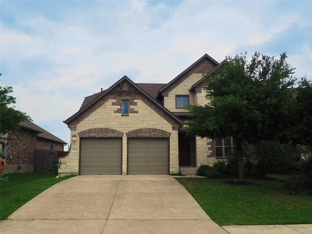 1902 Aves Cv, Pflugerville, TX 78660 - view of front of home featuring stone siding, concrete driveway, and a front lawn