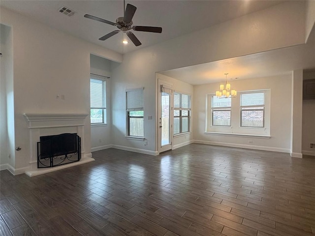 1902 Aves Cv, Pflugerville, TX 78660 - unfurnished living room with a chandelier, plenty of natural light, dark wood finished floors, and a ceiling fan