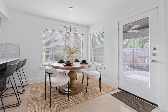 10300 Mourning Dove Dr, Austin, TX 78750 - dining space featuring baseboards, a chandelier, and ceiling fan