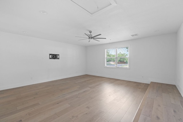10300 Mourning Dove Dr, Austin, TX 78750 - empty room with attic access, light wood-style floors, a ceiling fan, and baseboards