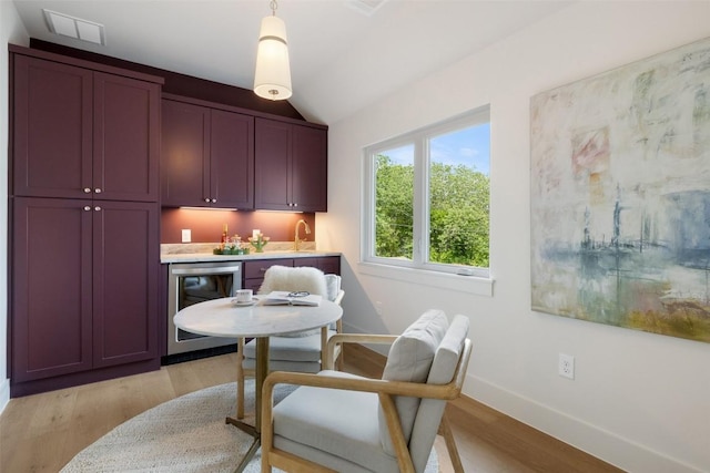4600 Parkdale Pl, Austin, TX 78745 - dining area with wine cooler, wet bar, light wood-type flooring, baseboards, and vaulted ceiling