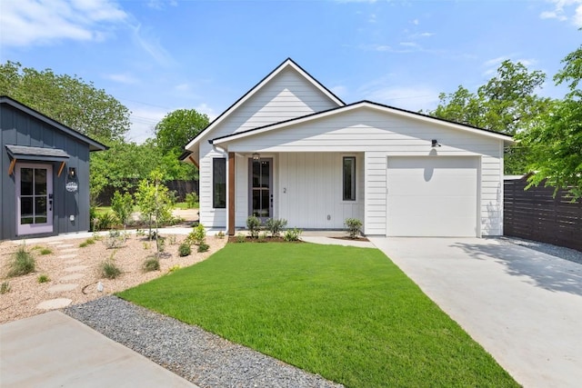 4600 Parkdale Pl, Austin, TX 78745 - view of front of house featuring an attached garage, board and batten siding, a front yard, and concrete driveway