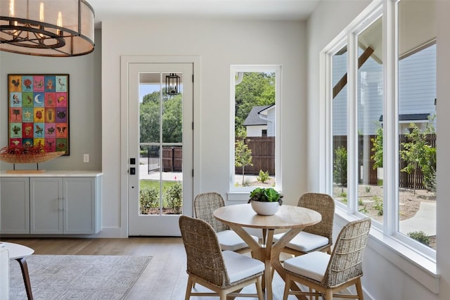 4600 Parkdale Pl, Austin, TX 78745 - dining room featuring a chandelier and light wood finished floors