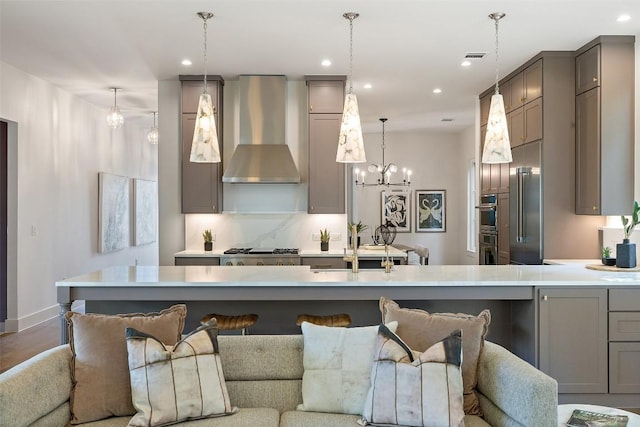 4600 Parkdale Pl, Austin, TX 78745 - kitchen featuring wall chimney range hood, open floor plan, recessed lighting, gray cabinetry, and light countertops