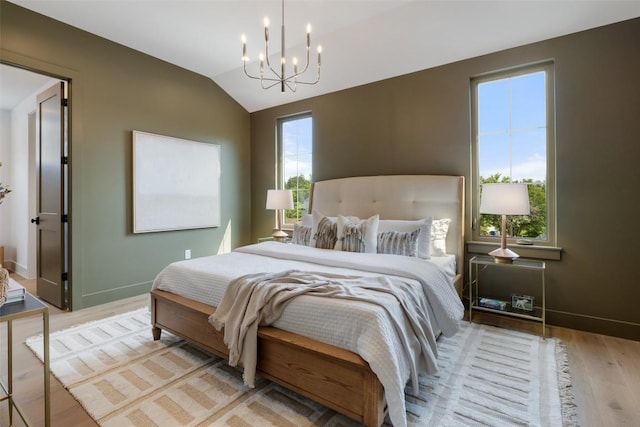 4600 Parkdale Pl, Austin, TX 78745 - bedroom with a chandelier, light wood-style floors, lofted ceiling, and baseboards