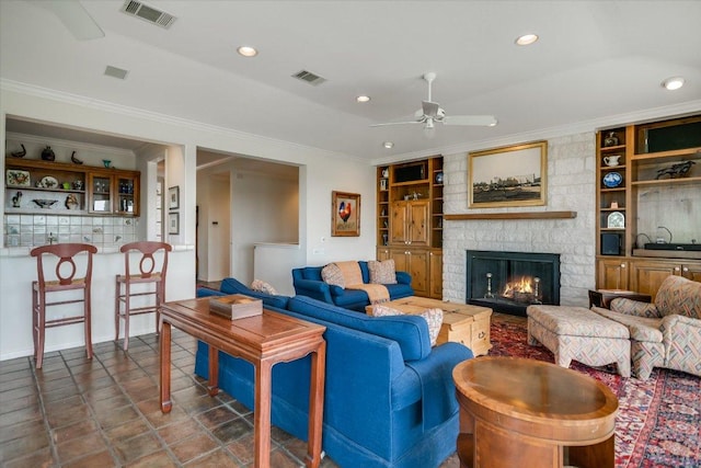 137 Firebird St, Lakeway, TX 78734 - living room with a ceiling fan, built in shelves, a fireplace, crown molding, and recessed lighting
