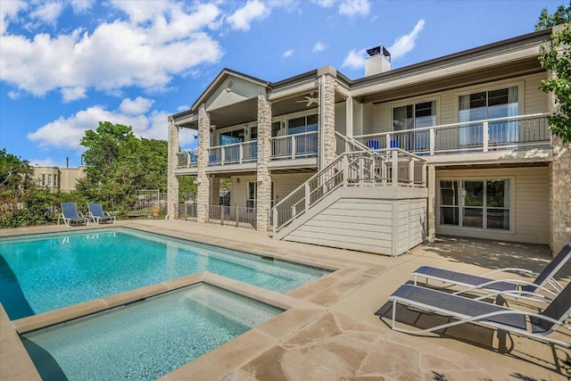 137 Firebird St, Lakeway, TX 78734 - back of property featuring stone siding, a chimney, stairs, a patio area, and ceiling fan