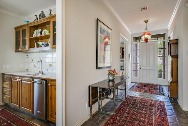 137 Firebird St, Lakeway, TX 78734 - entryway featuring ornamental molding, dark tile patterned floors, and baseboards